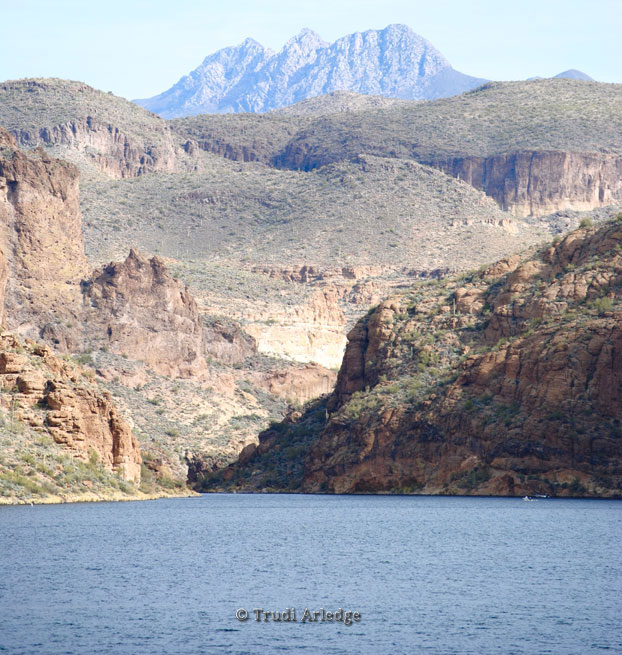View from Apache Trail Highway, Arizona State Route 88, used with permission of the photographer TA; copyright statement required by the photographer; A view of a lake in the foreground; mid-ground with red rock hills; background with jagged mountain ridge